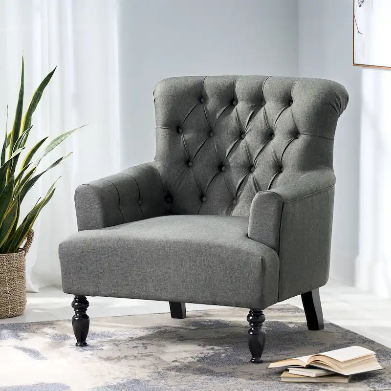 Fauteuil club capitonné à dossier roulé