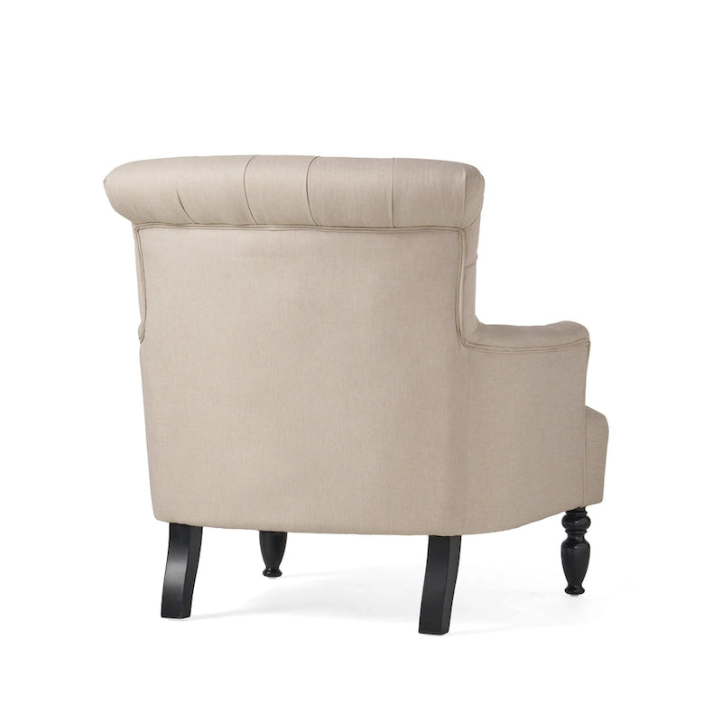 Fauteuil club capitonné à dossier roulé